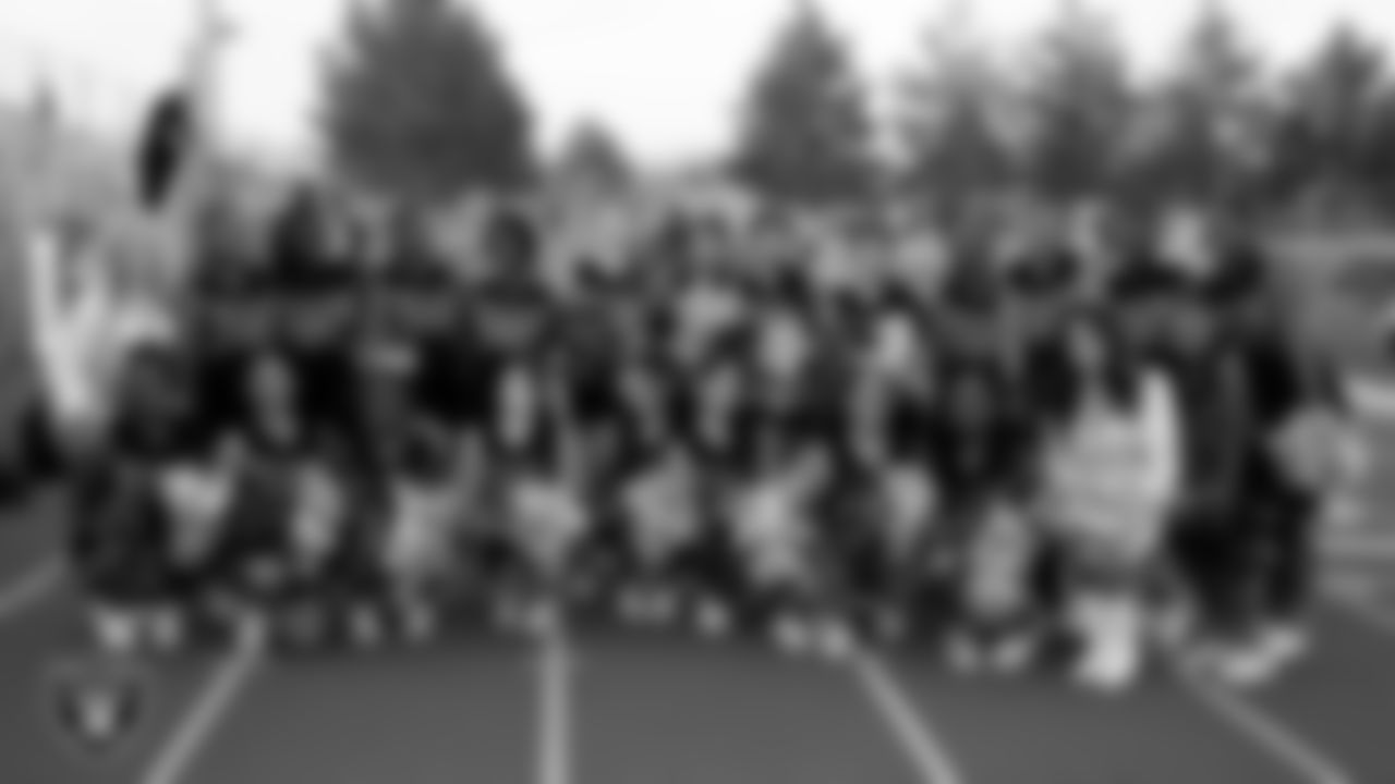 Raiderettes Megan and Tatiana pose for a photo with the Desert Pines High School cheerleaders before the Las Vegas Raiders' Football Showcase game between Desert Pines and Liberty High School at Desert Pines High School.