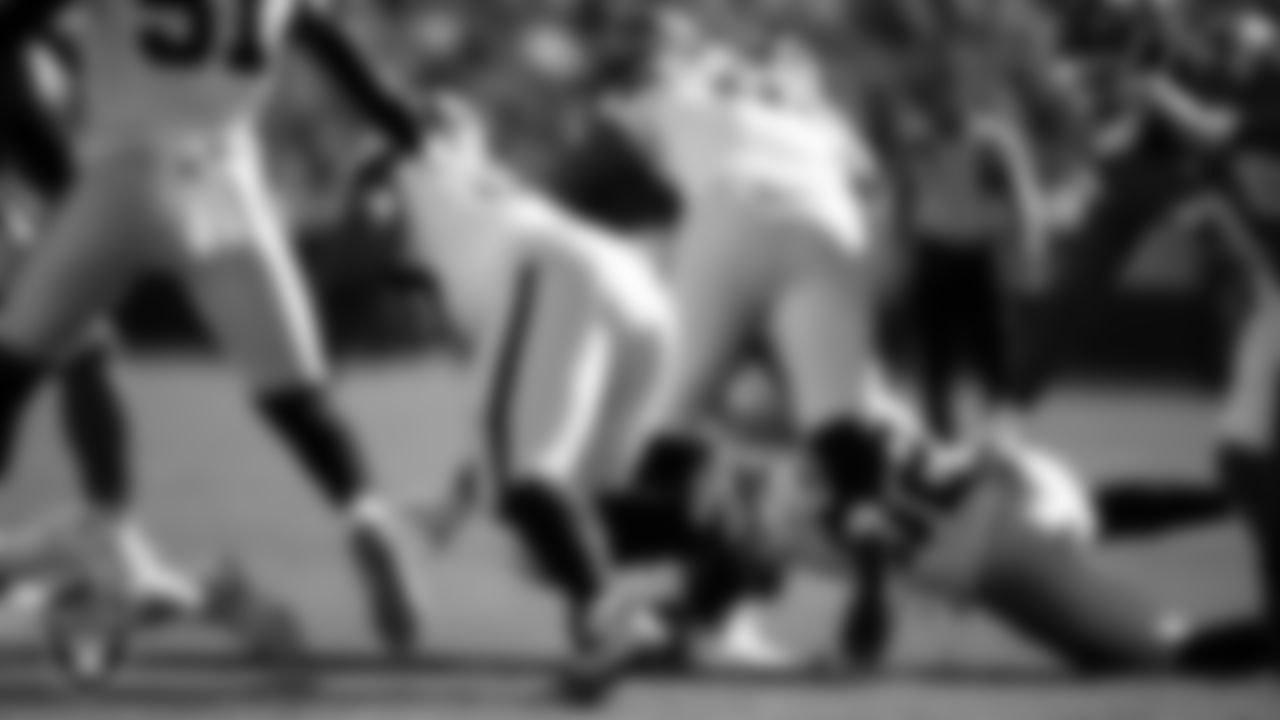 Las Vegas Raiders defensive tackle Jonah Laulu (96) and linebacker Elandon Roberts (52) make a tackle during the regular season away game against the Kansas City Chiefs at GEHA Field at Arrowhead Stadium.