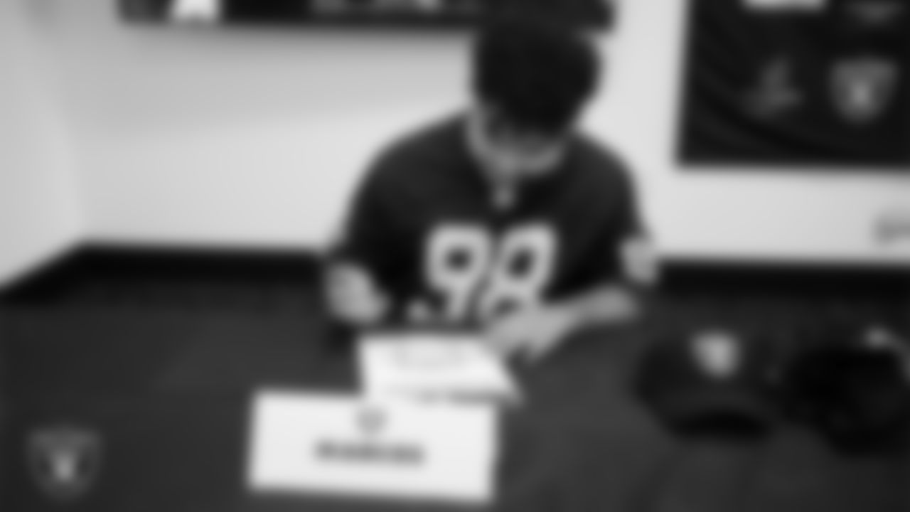 Marcos Carrillo from Make-A-Wish signs an honorary Raider contract in the Ubeo press conference room during a visit to Intermountain Health Performance Center.