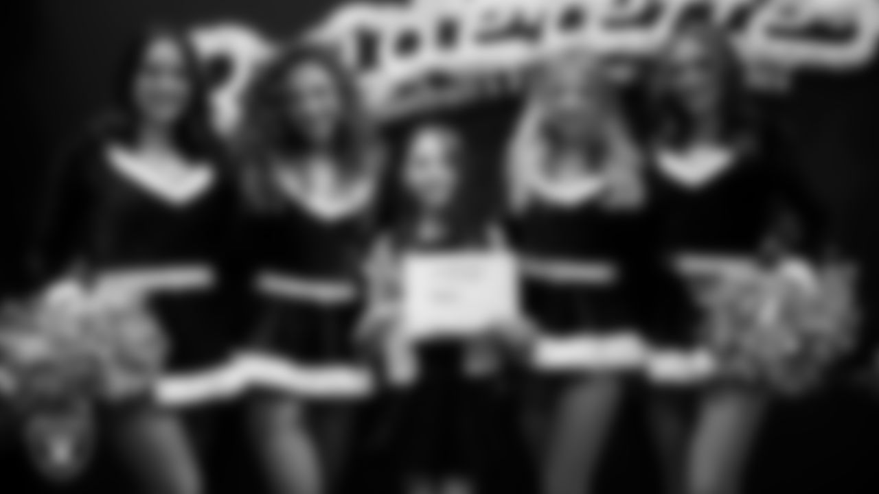 Raiderettes pose for a photo with a Junior Raiderette during the Junior Raiderettes Banquet at The Studio.