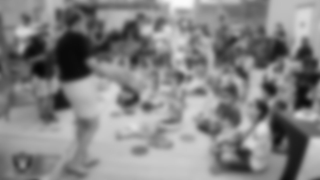 Henderson Libraries Outreach Librarian Tracy reads to guests during a Las Vegas Raiders library card launch event at The Lion Habitat Ranch.