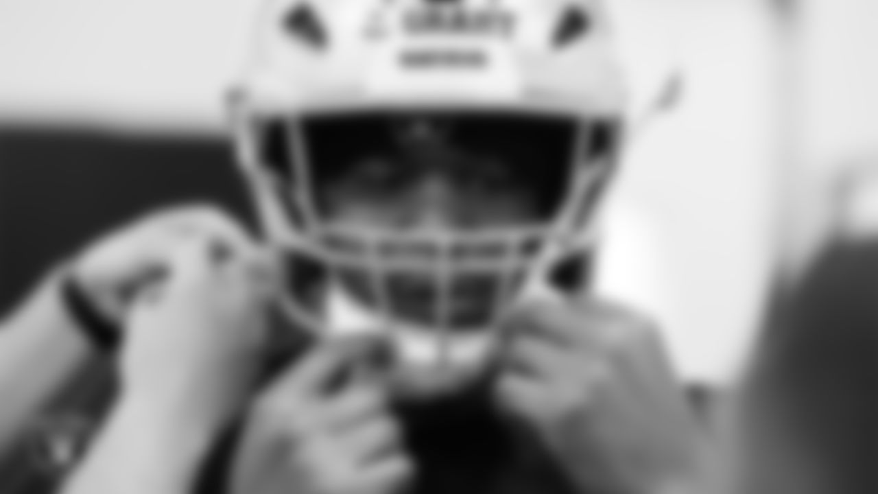 Las Vegas Raiders tackle Charles Grant (60) tries on a helmet in the equipment room at Intermountain Health Performance Center before the start of 2025 Rookie Minicamp.