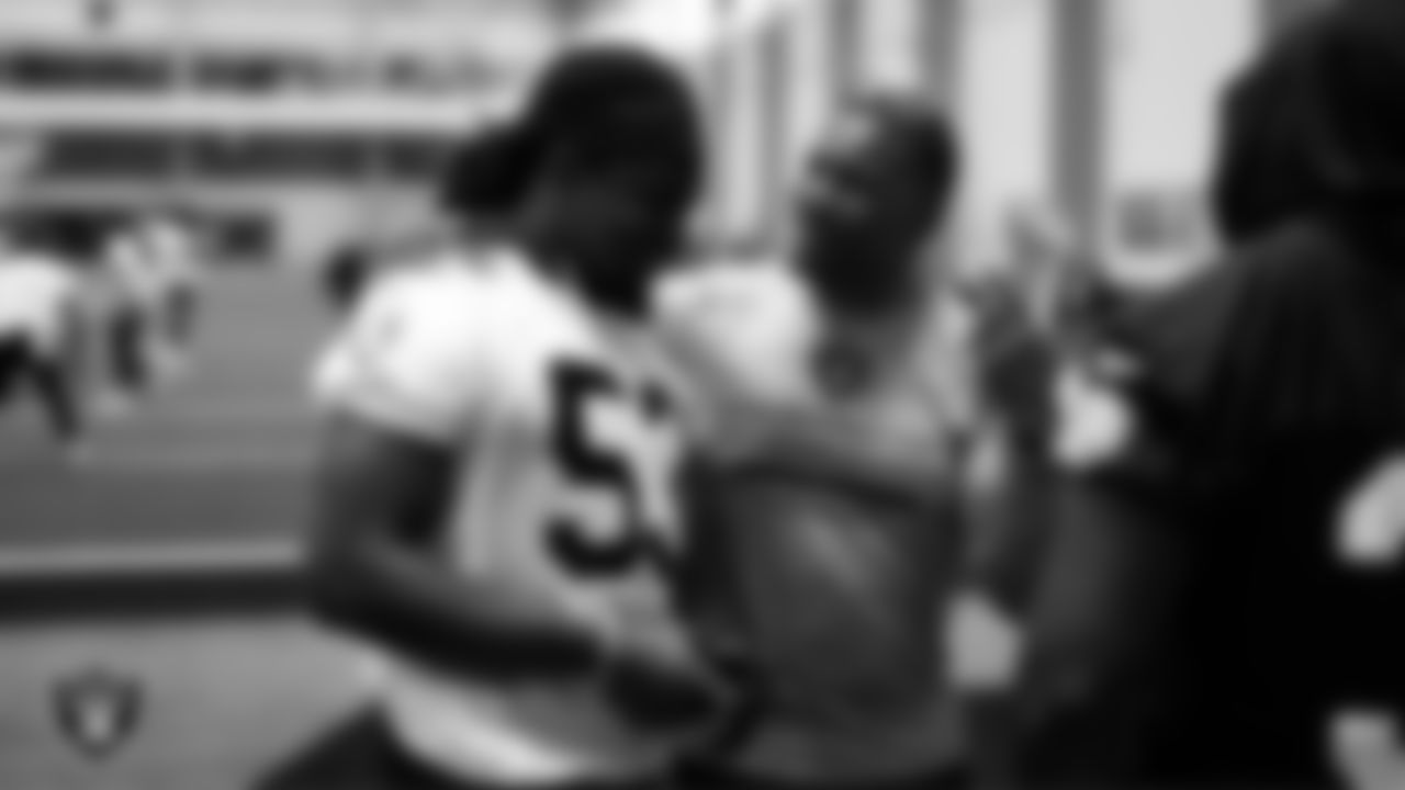Las Vegas Raiders linebacker Brian Asamoah II (53) and running backs coach Deland McCullough during practice at Intermountain Health Performance Center.