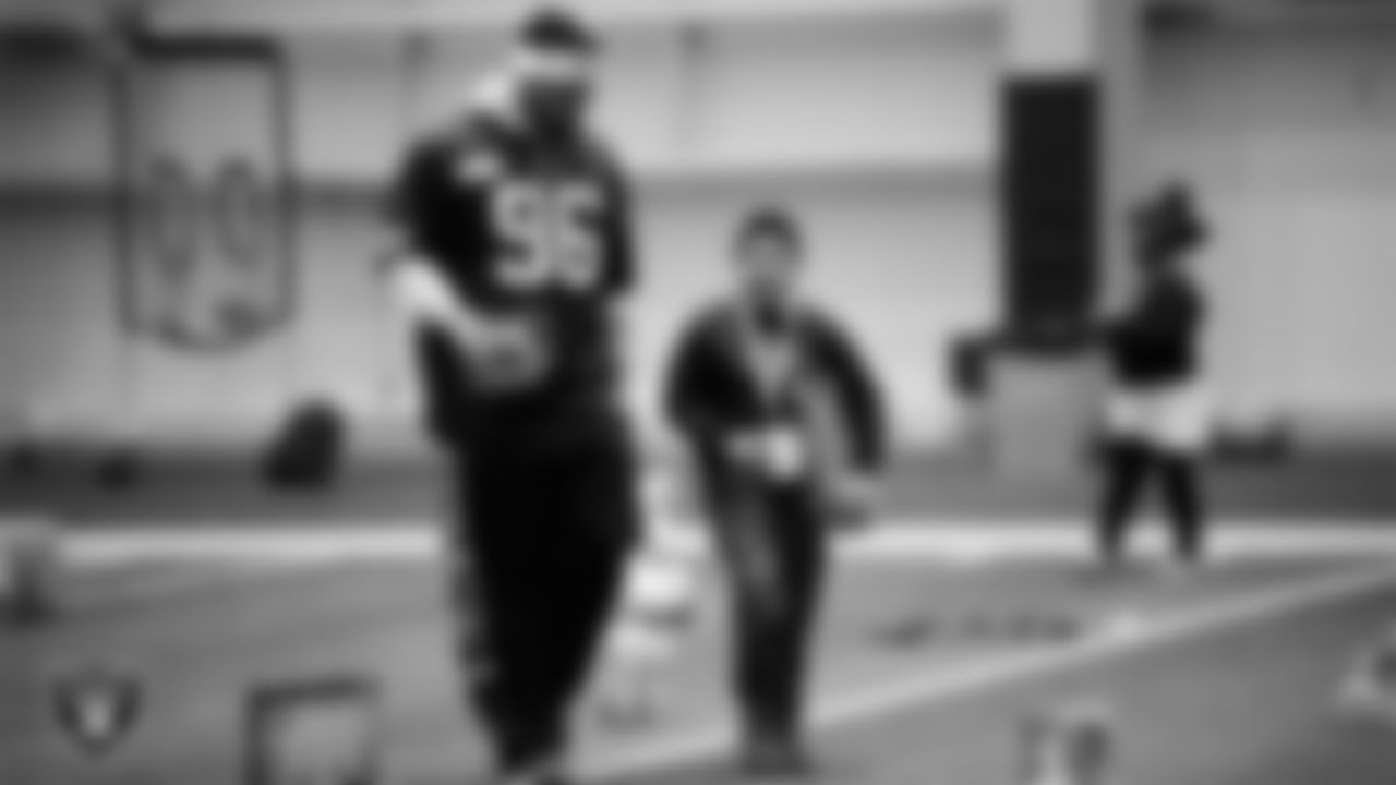 Las Vegas Raiders defensive tackle Jonah Laulu (96) helps a student select toys during a Raiders Youth Holiday Party at Intermountain Health Performance Center.