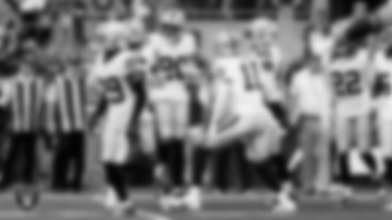 Las Vegas Raiders safety Isaiah Pola-Mao (20) celebrates with teammates after intercepting a pass during the preseason away game against the Seattle Seahawks at Lumen Field.