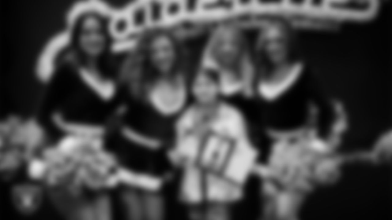 Raiderettes pose for a photo with a Junior Raiderette during the Junior Raiderettes Banquet at The Studio.