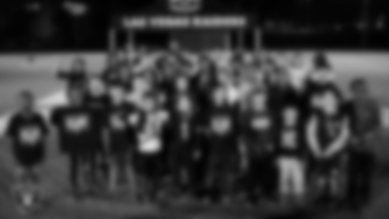 Athletes pose for a photo after a Silver and Black League flag football clinic at Bill and Lillie Heinrich YMCA.