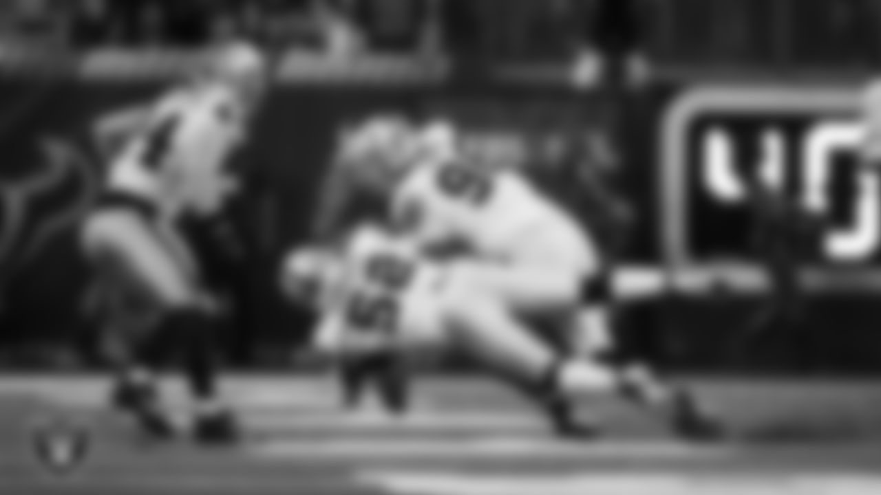Las Vegas Raiders linebacker Elandon Roberts (52) and defensive tackle Jonah Laulu (96) make a tackle during the regular season away game against the Houston Texans at NRG Stadium.