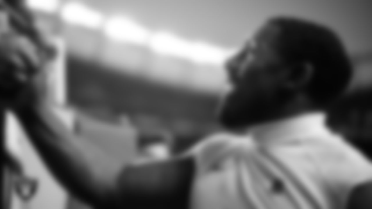 Las Vegas Raiders defensive tackle Thomas Booker IV (99) with fans before the regular season away game against the Denver Broncos at Empower Field at Mile High.