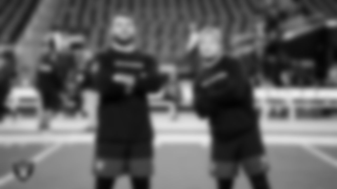 Las Vegas Raiders linebacker Jon Rhattigan (59) and running back Dylan Laube (23) warming up before the regular season home game against the Dallas Cowboys at Allegiant Stadium.