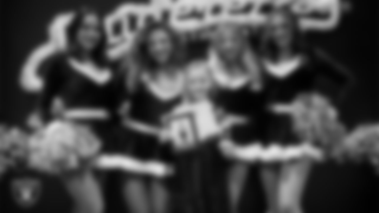 Raiderettes pose for a photo with a Junior Raiderette during the Junior Raiderettes Banquet at The Studio.