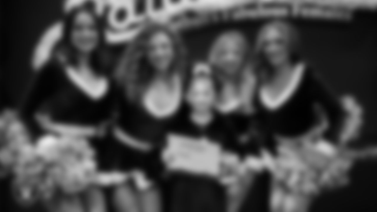 Raiderettes pose for a photo with a Junior Raiderette during the Junior Raiderettes Banquet at The Studio.