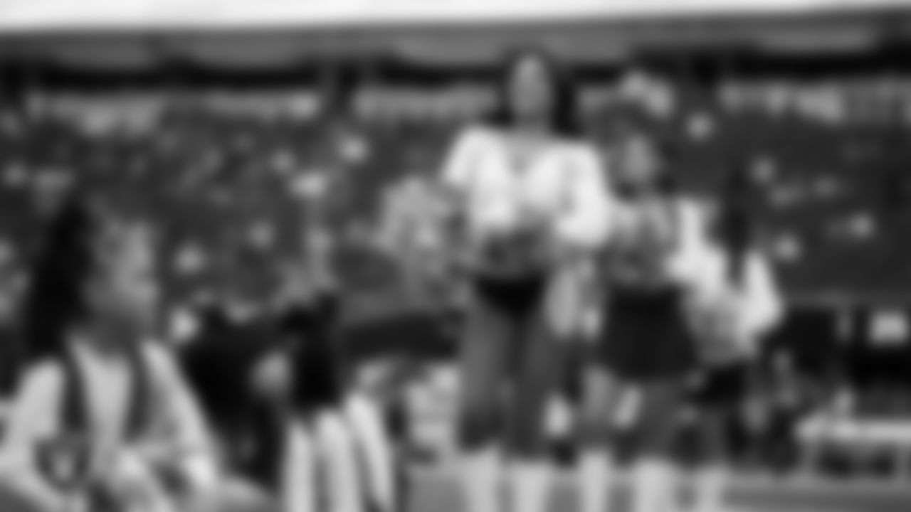 Raiderette Bria and Junior Raiderettes perform on the field before the preseason home game against the San Francisco 49ers at Allegiant Stadium.