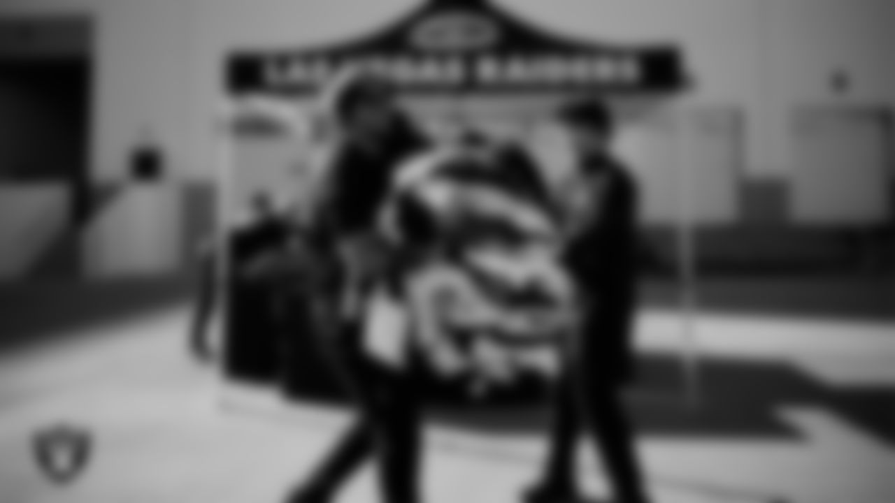 Las Vegas Raiders ambassadors load equipment into a vehicle during the Raiders' Equipment Blitz at Intermountain Health Performance Center.