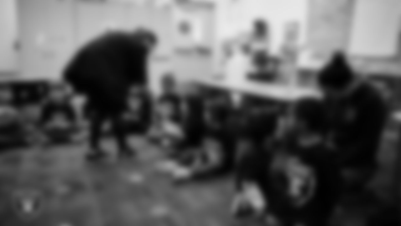 Las Vegas Raiders director of marketing communications Nell Warkoski hands out stickers to students at Richard H. Bryan Elementary School.