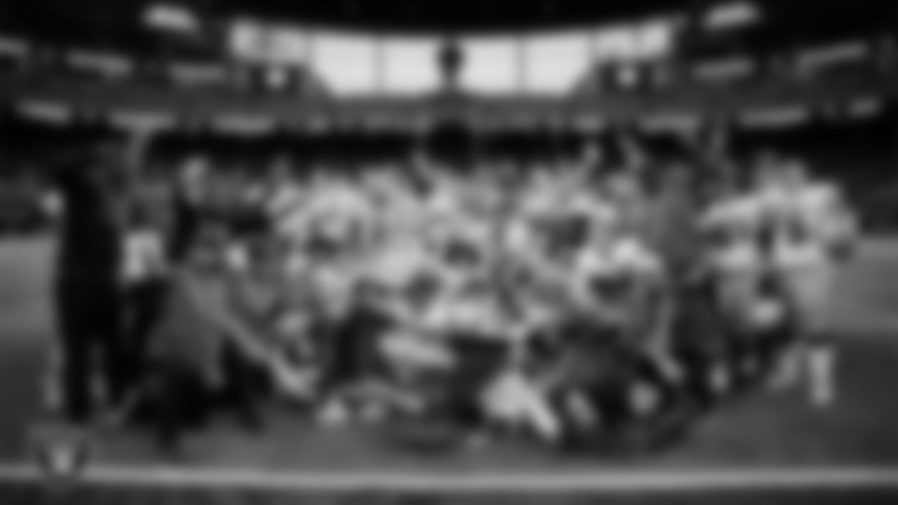 The McQueen High School football team poses for a photo after defeating Pinecrest Academy - Sloan Canyon in the NIAA 4A Division State Championship game at Allegiant Stadium.