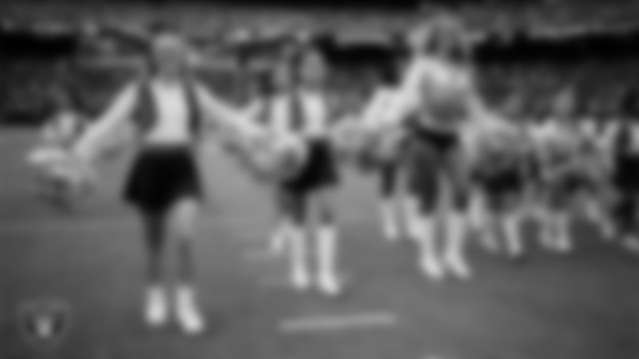 Raiderette Jessica and Junior Raiderettes exit the field after their performance before the preseason home game against the San Francisco 49ers at Allegiant Stadium.