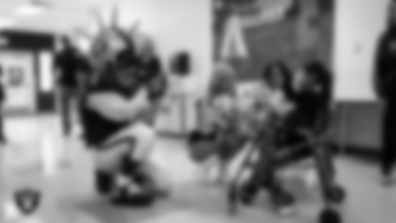 Raider Rusher and Raiderettes Pip and Sloane speak to a student during a 'Lil Raiders Pop-Up at Richard H. Bryan Elementary School.