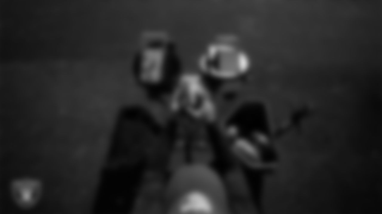 A Las Vegas Raiders coach works with the JUGS machine during practice at Intermountain Health Performance Center.