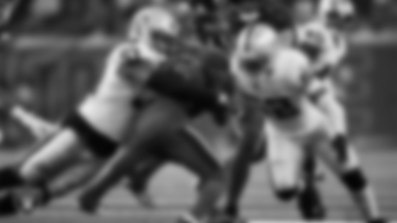 Las Vegas Raiders defensive end Malcolm Koonce (51) and linebacker Elandon Roberts (52) make a tackle during the regular season away game against the Houston Texans at NRG Stadium.