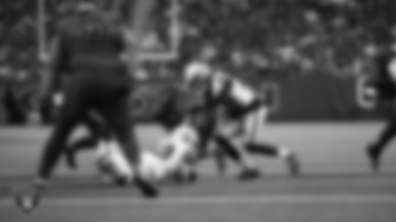 Las Vegas Raiders linebacker Elandon Roberts (52) and cornerback Eric Stokes (22) make a tackle during the regular season away game against the Houston Texans at NRG Stadium.