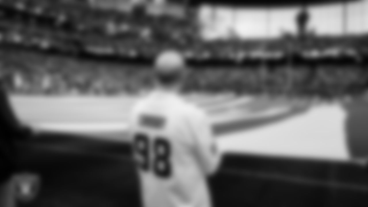 The American flag is displayed by Personal Seat License (PSL) holders on the field during the national anthem before the Las Vegas Raiders' regular season home game against the Denver Broncos at Allegiant Stadium.