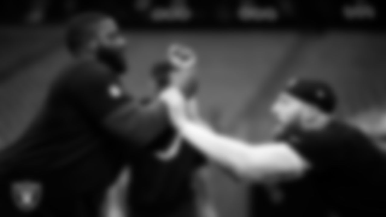 Las Vegas Raiders assistant defensive line coach Kenyon Jackson and defensive end Maxx Crosby (98) warming up before the regular season away game against the Houston Texans at NRG Stadium.