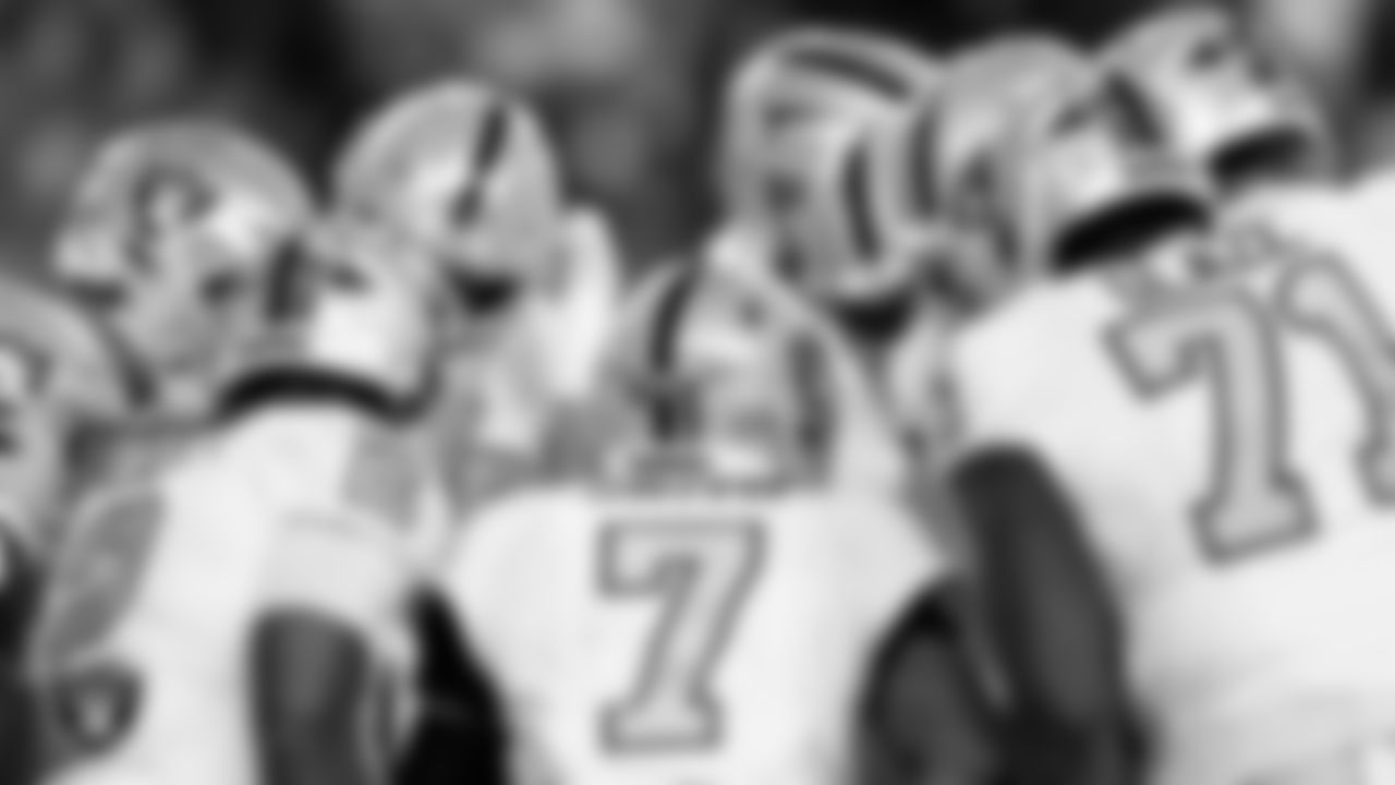 The Las Vegas Raiders huddle during the regular season away game against the Denver Broncos at Empower Field at Mile High.