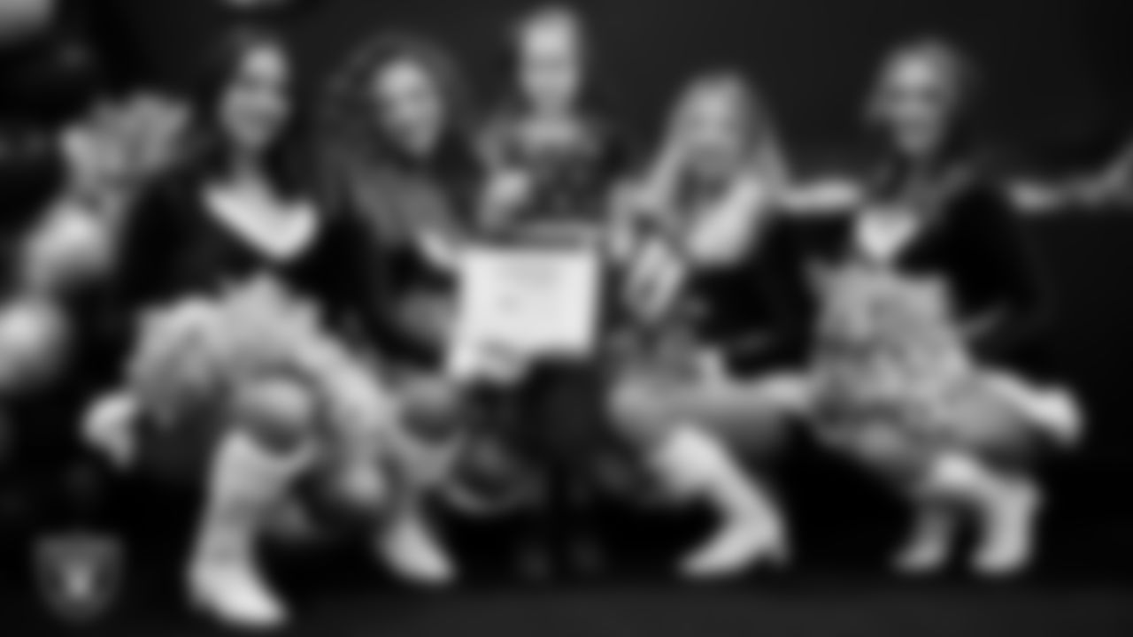 Raiderettes pose for a photo with a Junior Raiderette during the Junior Raiderettes Banquet at The Studio.