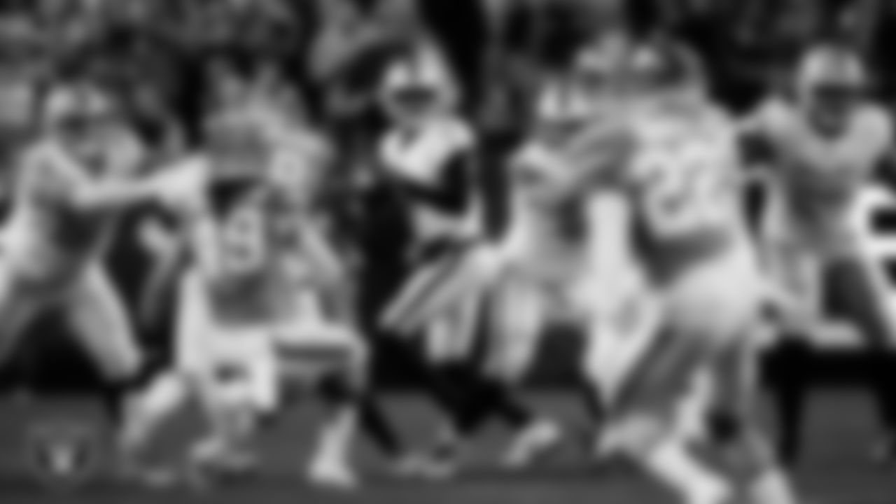 Las Vegas Raiders quarterback Geno Smith (7) looks for a receiver during the regular season away game against the Denver Broncos at Empower Field at Mile High.