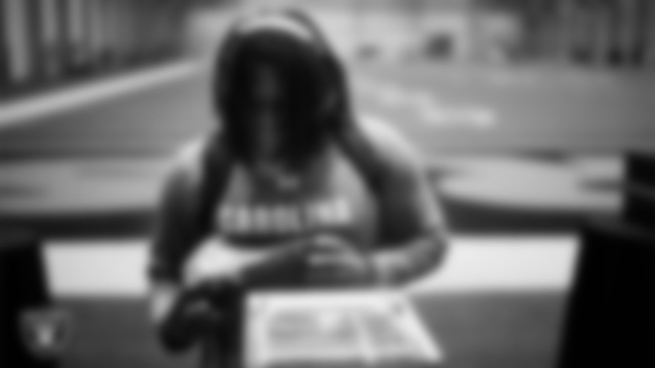 Las Vegas Raiders defensive tackle Tonka Hemingway (97) unboxes his custom cleats for the NFL's My Cause My Cleats initiative at Intermountain Health Performance Center.