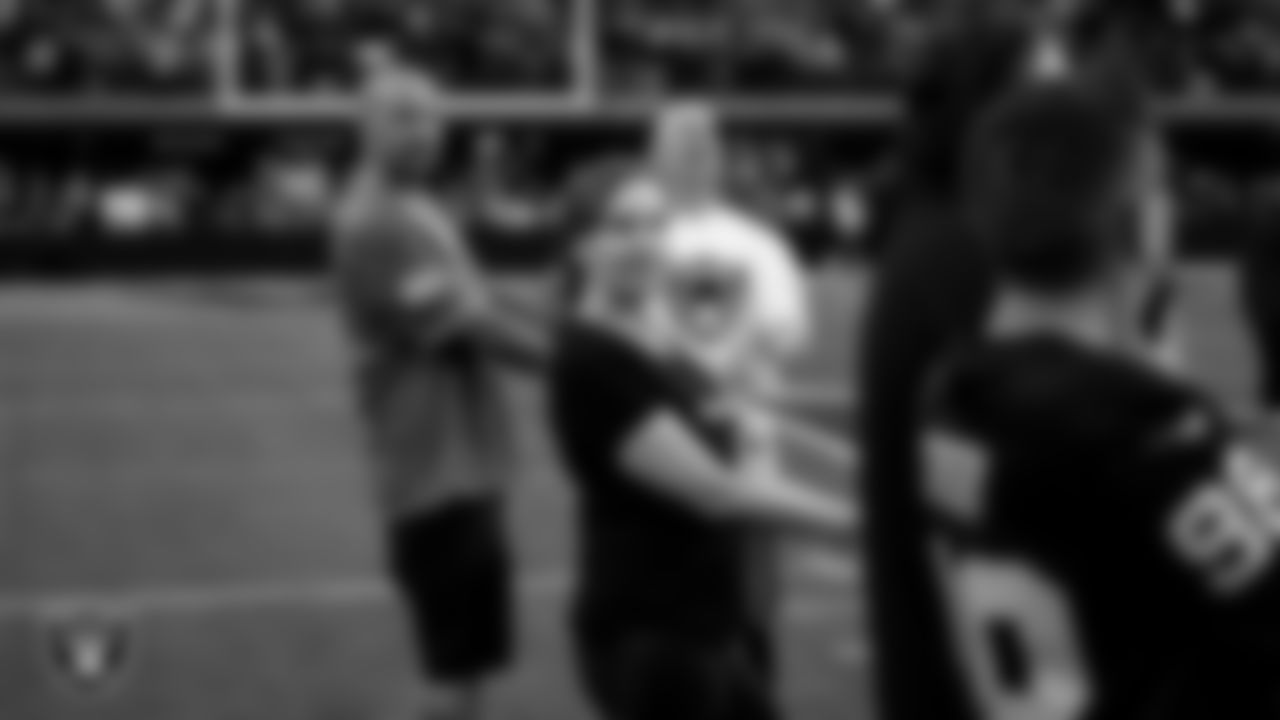 The American flag is displayed by Personal Seat License (PSL) holders on the field during the national anthem before the Las Vegas Raiders' regular season home game against the Jacksonville Jaguars at Allegiant Stadium.