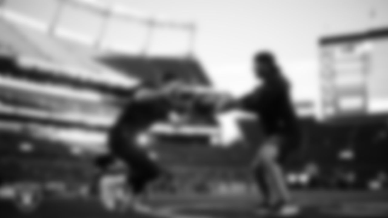 Las Vegas Raiders defensive end Maxx Crosby (98) and run game coordinator/defensive line coach Rob Leonard warming up before the regular season away game against the Denver Broncos at Empower Field at Mile High.