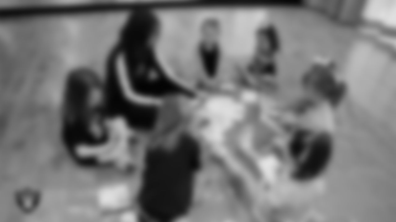 Raiderette Ashtin colors with dancers during day one of summer camp at The Studio.