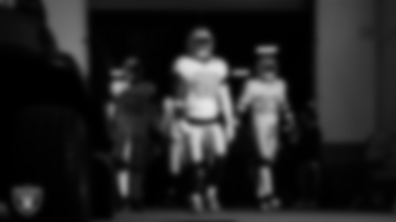 Las Vegas Raiders linebacker Elandon Roberts (52), linebacker Devin White (45) and linebacker Jamal Adams (33) walk down the tunnel before the regular season away game against the Denver Broncos at Empower Field at Mile High.