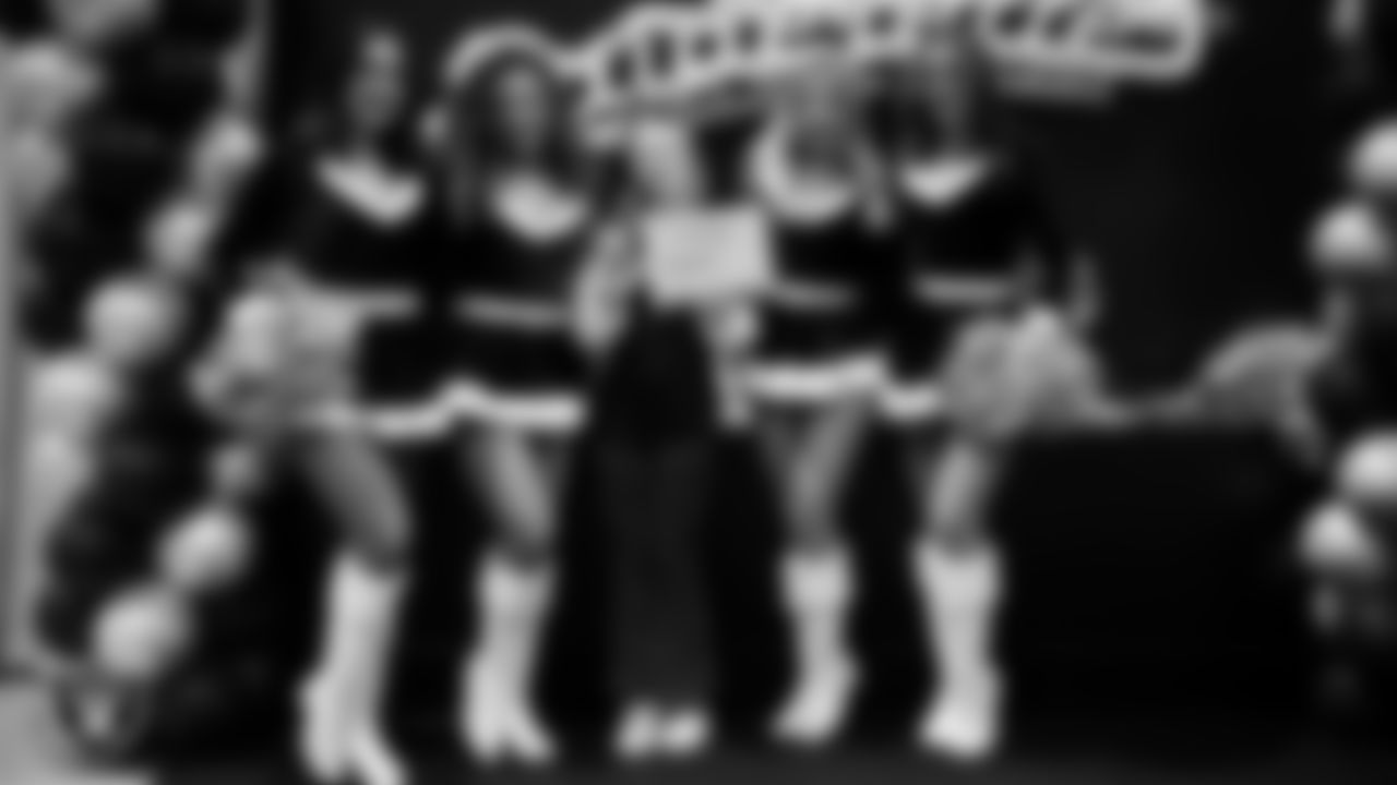 Raiderettes pose for a photo with a Junior Raiderette during the Junior Raiderettes Banquet at The Studio.