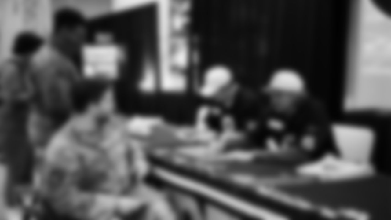 Las Vegas Raiders kicker Daniel Carlson (8) and punter AJ Cole (6) sign autographs for service members at Nellis Air Force Base.