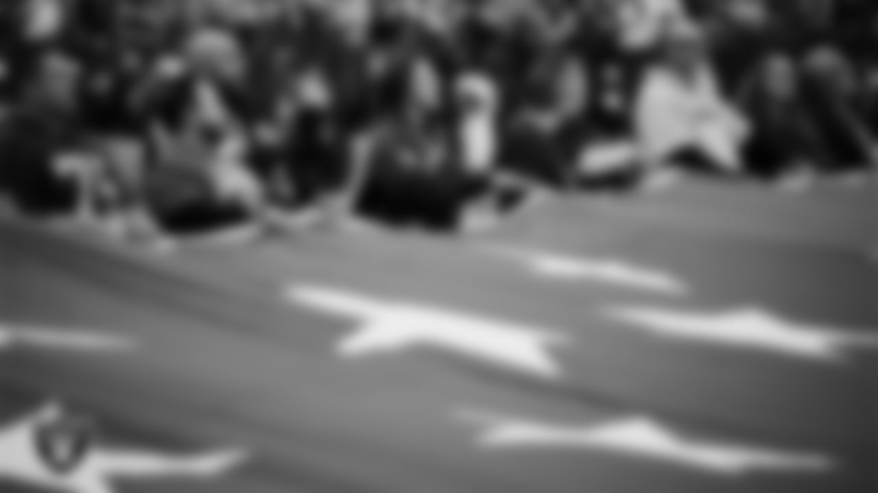 The American flag is displayed by Personal Seat License (PSL) holders on the field during the national anthem before the Las Vegas Raiders' regular season home game against the New York Giants at Allegiant Stadium.