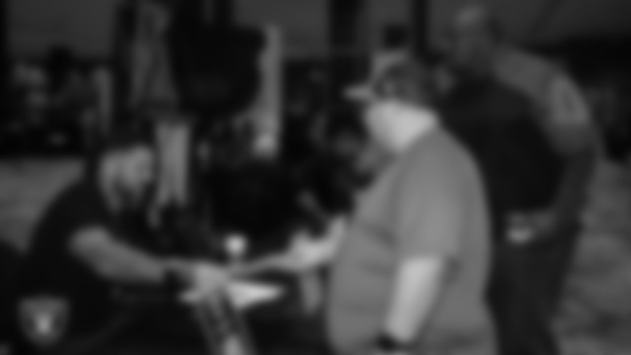 Las Vegas Raiders alumnus Robert Gallery signs autographs for high school football coaches during a Glazier Clinic at Grand Sierra Resort.