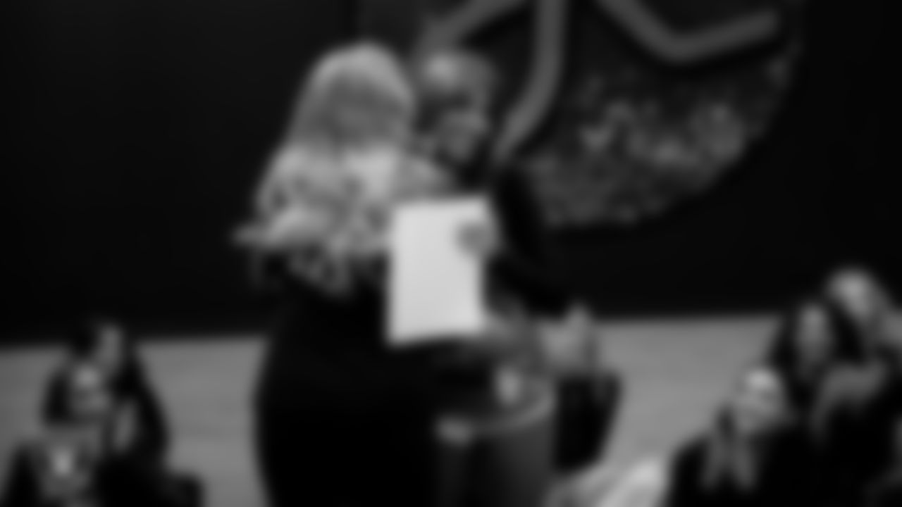 Raiderettes Director Tiphanie McNiff presents a Silver Ticket to a dancer after a recruitment clinic at The Studio.