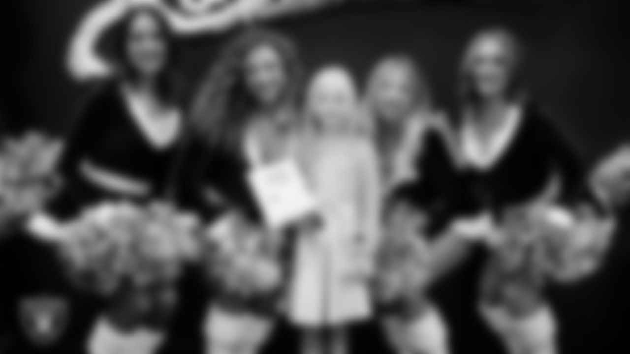 Raiderettes pose for a photo with a Junior Raiderette during the Junior Raiderettes Banquet at The Studio.