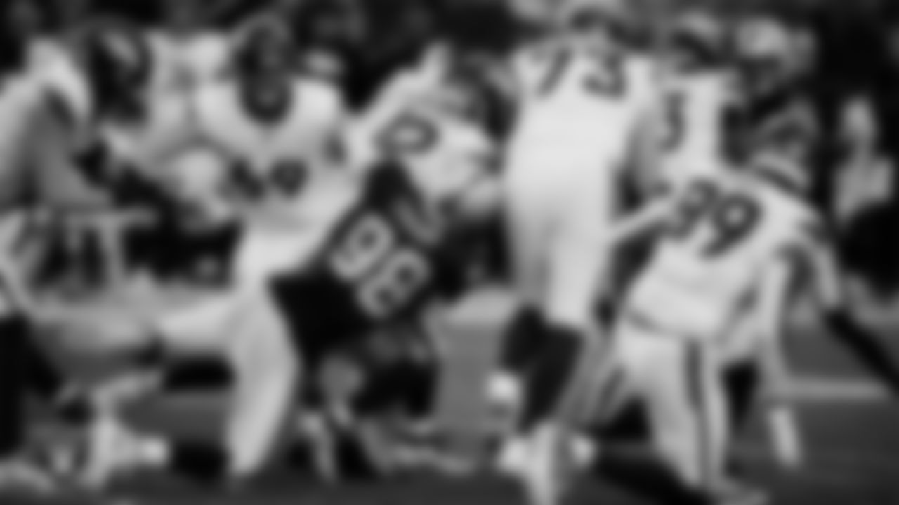 Las Vegas Raiders defensive end Maxx Crosby (98) makes a tackle during the regular season home game against the Denver Broncos at Allegiant Stadium.