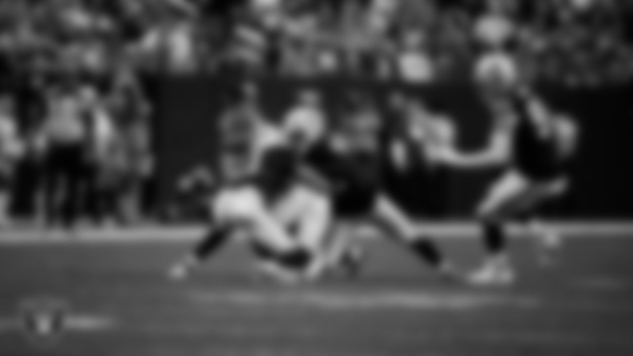 Las Vegas Raiders safety Jeremy Chinn (11) and linebacker Devin White (45) make a tackle during the regular season home game against the Denver Broncos at Allegiant Stadium.