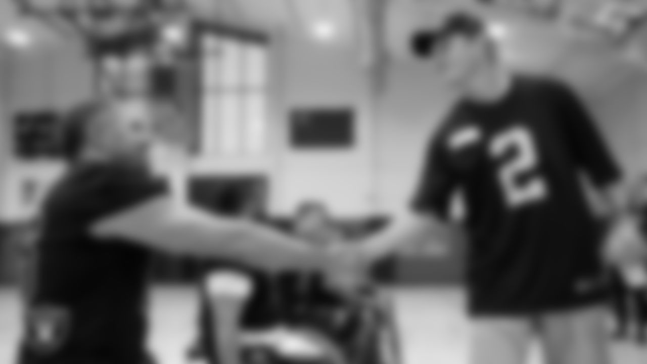 Las Vegas Raiders kicker Daniel Carlson (2) shakes hands with a member of the City of Las Vegas Wheelchair Football League during practice at Dula Community Center.