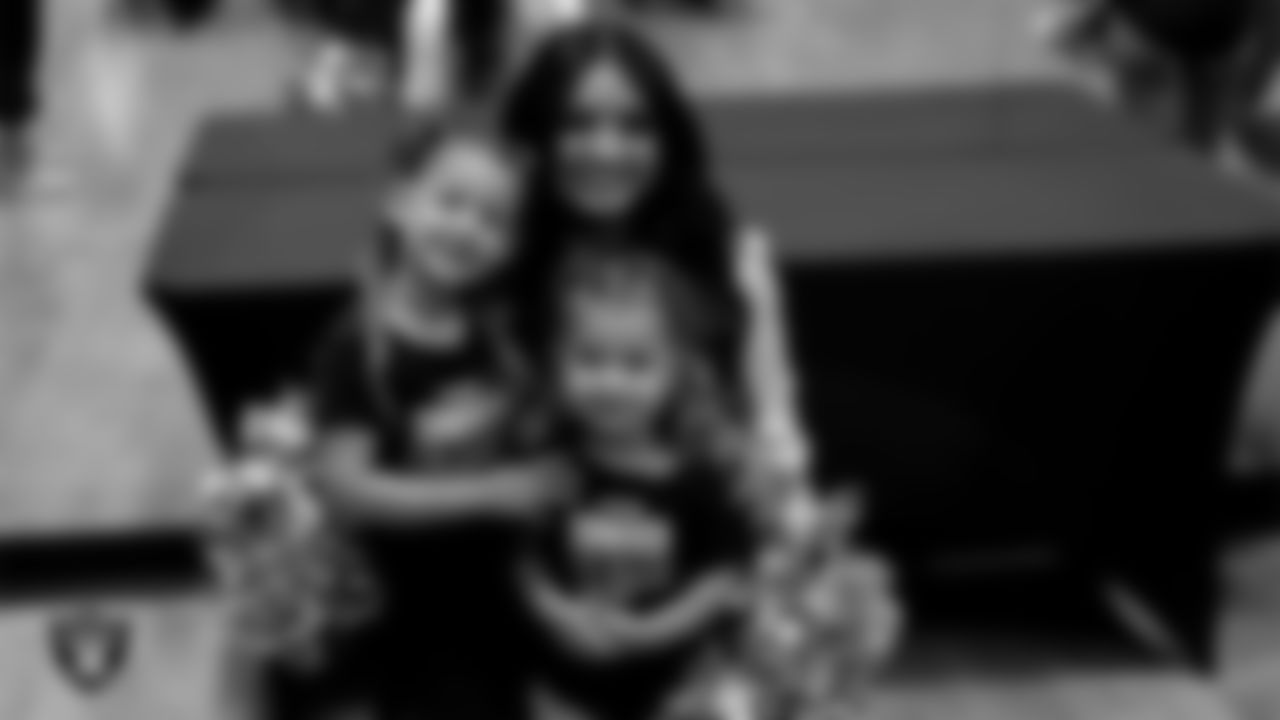 Raiderette Sloane poses for a photo with dancers during day three of summer camp at The Studio.