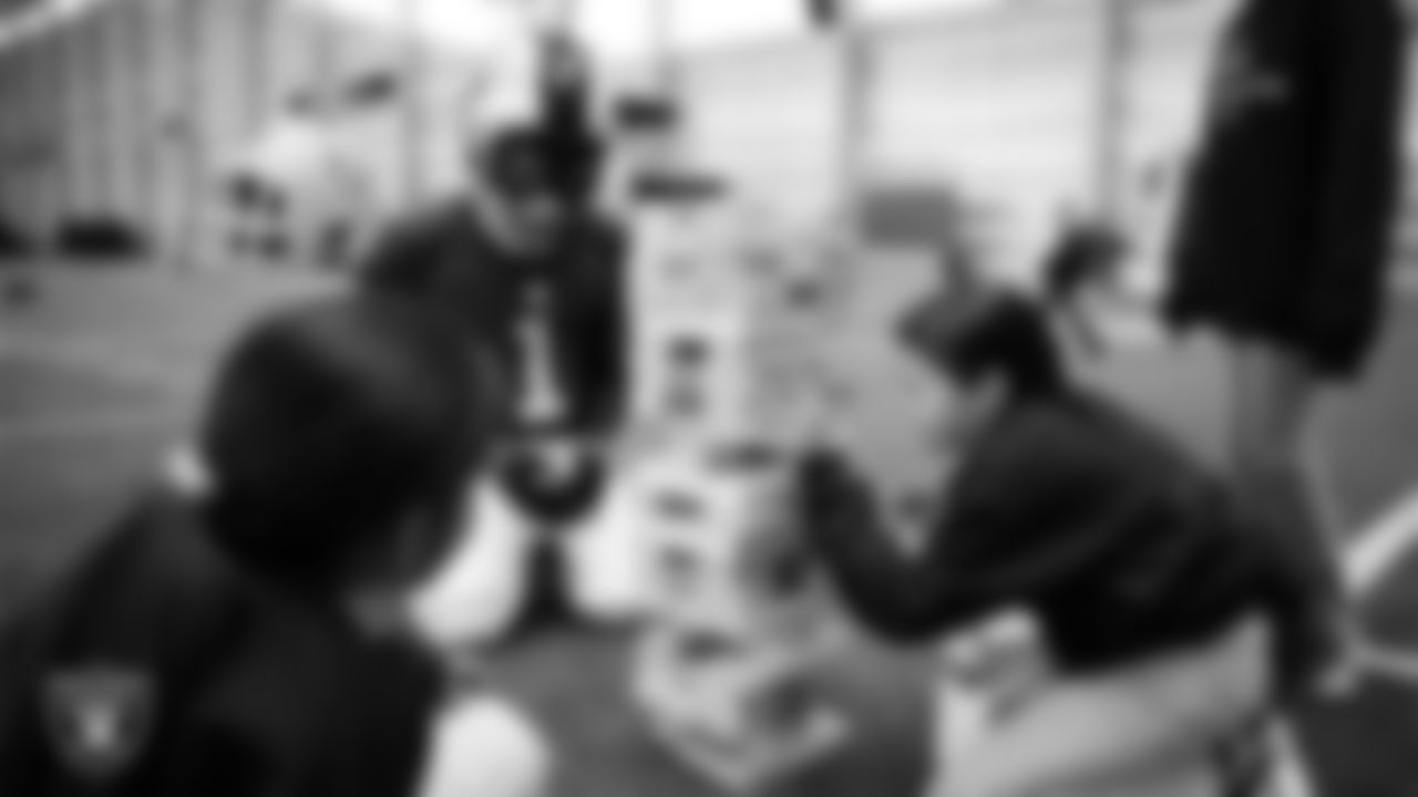 Raider Rusher and students enjoy an activity during a Raiders Youth Holiday Party at Intermountain Health Performance Center.