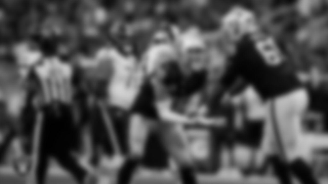 Las Vegas Raiders defensive end Maxx Crosby (98) and defensive tackle Adam Butler (69) celebrate on the field during the regular season home game against the Chicago Bears at Allegiant Stadium.