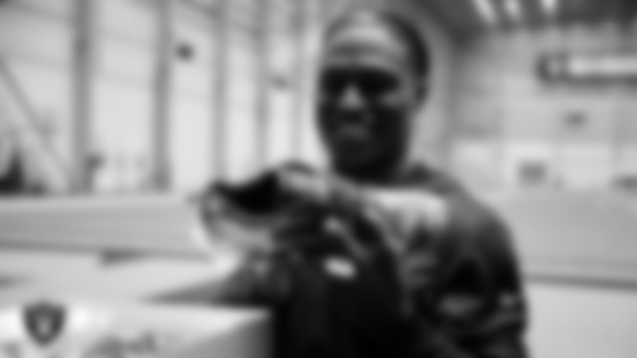 Las Vegas Raiders cornerback Darnay Holmes (30) unboxes his custom cleats for the NFL's My Cause My Cleats initiative at Intermountain Health Performance Center.