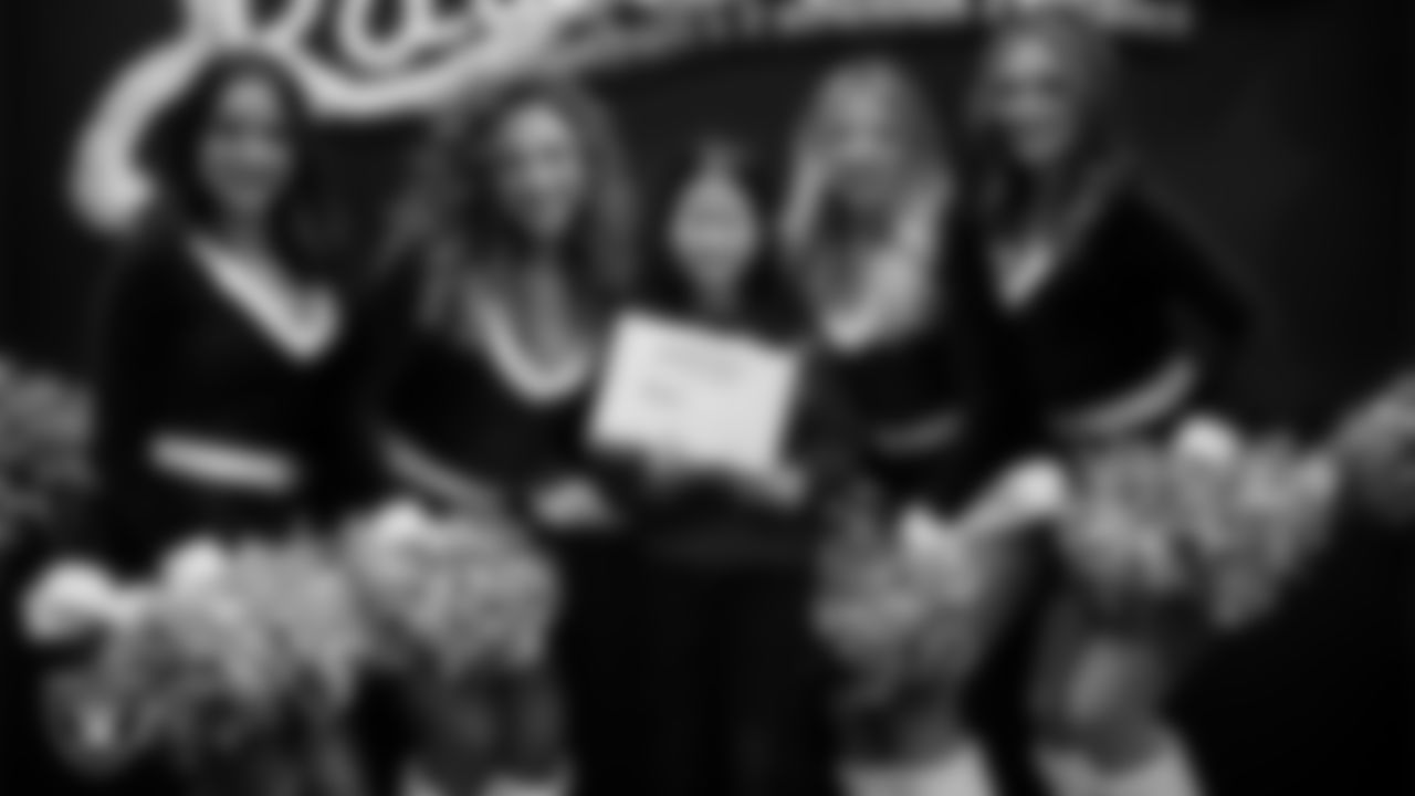 Raiderettes pose for a photo with a Junior Raiderette during the Junior Raiderettes Banquet at The Studio.