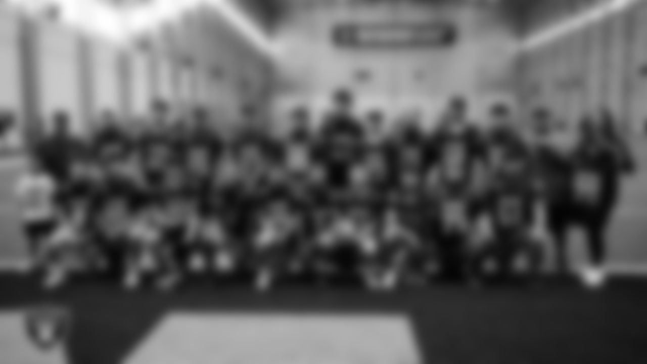 The Owyhee High School football team poses for a photo in their new uniforms at Intermountain Health Performance Center.